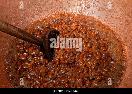 Sugar coated almonds being hand roasted. Stock Photo