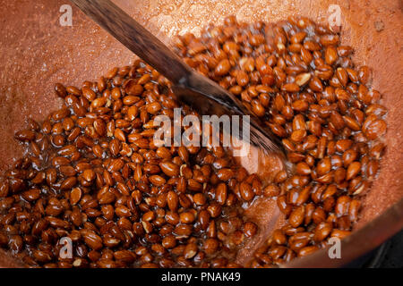 Sugar coated almonds being hand roasted. Stock Photo