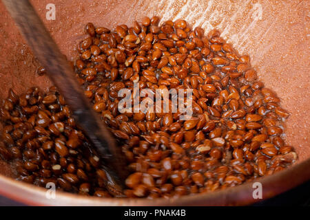 Sugar coated almonds being hand roasted. Stock Photo