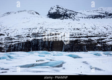 Group of tourists walking on adventure trek on Svinafellsjokull glacier an outlet glacier of Vatnajokull, South Iceland Stock Photo