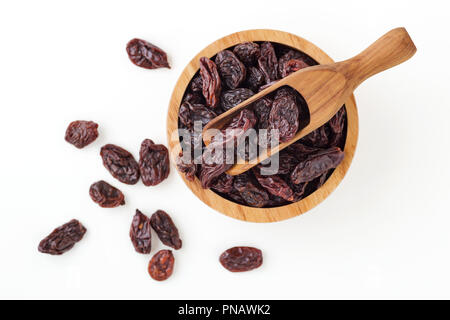 Raisins in wooden bowl isolated on white background Stock Photo