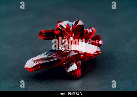 red crystal of natural origin. close up of crystals in ruby color on black background Stock Photo
