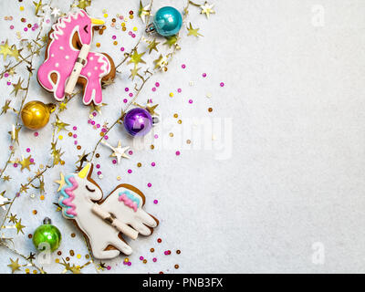 On a white textural background, multi-colored Christmas balls of a single figure, colored confetti, a golden garland horizontally with copy space Stock Photo