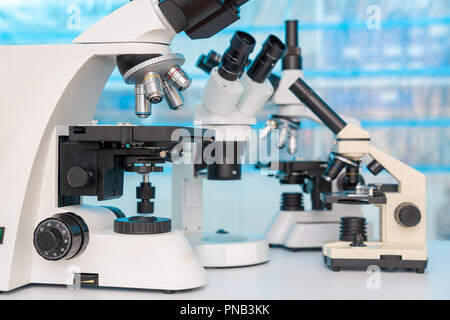 Four microscopes of different designs in the laboratory Stock Photo