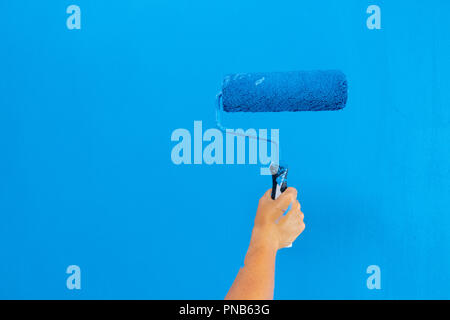 Someone painting wall Stock Photo