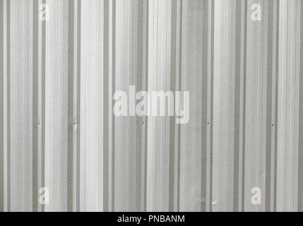 Corrugated metal wall and drop water , detail of lined  shiny steel Stock Photo