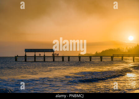 Sunset at the Waimea Pier as nearby wildfire's smoke fills the sky Stock Photo