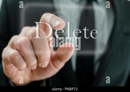 Businessman touching Delete button on a virtual screen. Stock Photo