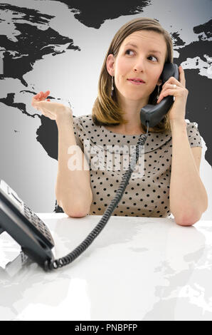 Female customer support operator talking on a telephone with virtual earth map behind her. Stock Photo