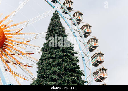 A Christmas tree and a Ferris wheel on the town square in Berlin during the Christmas holidays. Stock Photo