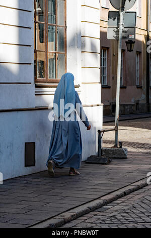 The nun hurrying down the street Stock Photo