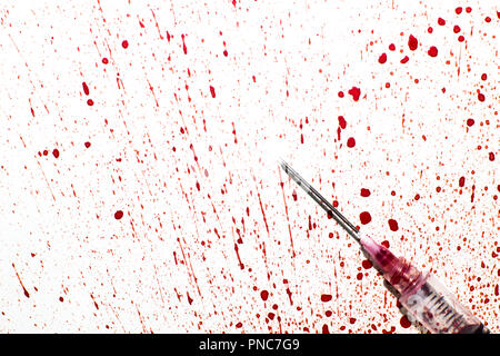 A syringe with sprayed blood on a white background