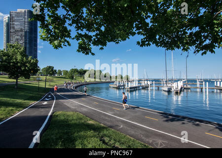 Joggers on Lakefront Trail with Lake Point Tower Condominium, Lake Michigan, Chicago, IL. Stock Photo