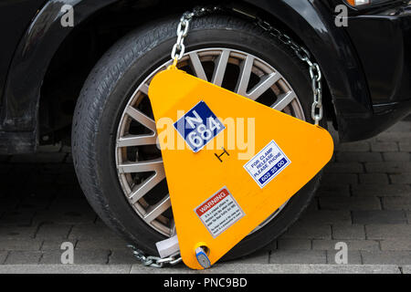 Dublin, Republic of Ireland - August 13th 2018: A close-up of a wheel clamp on a vehicle in the city of Dublin, on 13th August 2018. Stock Photo