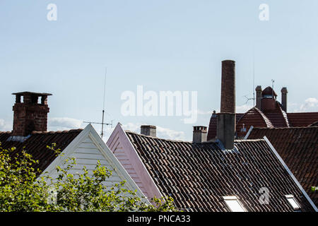 Close-up of houses with red tile roof, chimney, attic, windows and downspout in Munich, Germany Stock Photo