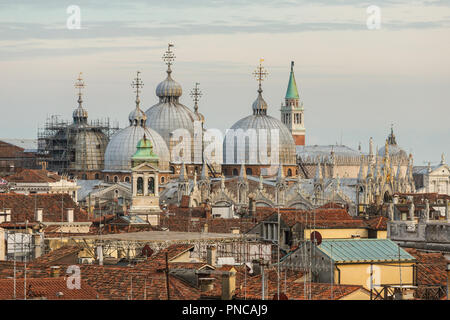 Basilica di San Marco and roofs of the old venetioan buildings at sunset in Venice, Italy Stock Photo