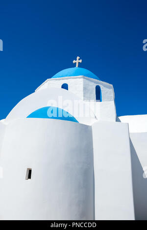 Cycladic greek orthodox church on Paros island, Greece. White cross against blue sky Stock Photo