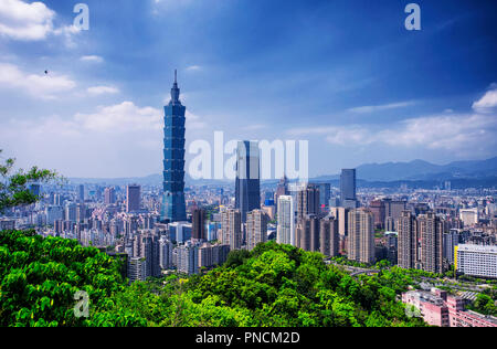 The Taipei 101 landmark building rising above generic architecture in the city of Taipei Taiwan on a sunny day as seen from Xiangshan or Elephant Moun Stock Photo