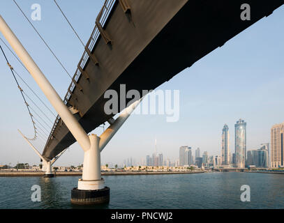 View of footbridge crossing the new Dubai Water Canal a waterway that connects into Dubai Creek and the sea. UAE, United Arab Emirates Stock Photo