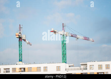 two cranes on the construction site. new buildings are being built Stock Photo