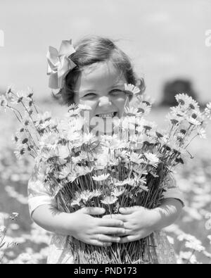 1930s SMILING HAPPY LITTLE GIRL LOOKING AT CAMERA HOLDING A BIG BUNCH OF FRESHLY PICKED DAISIES FLOWERS - f6046 HAR001 HARS NATURE COPY SPACE FRIENDSHIP HALF-LENGTH CONFIDENCE EXPRESSIONS B&W DAISY SUMMERTIME EYE CONTACT BRUNETTE DAISIES FRESH HAPPINESS CHEERFUL EXCITEMENT PRIDE PICKED SMILES BUNCH JOYFUL FRESHLY GROWTH JUVENILES SPRINGTIME BLACK AND WHITE CAUCASIAN ETHNICITY HAR001 OLD FASHIONED Stock Photo