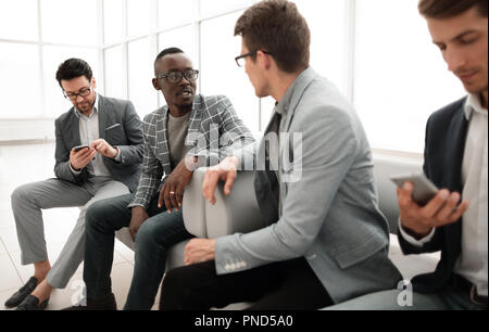 group of employees sitting in the office lobby. Stock Photo