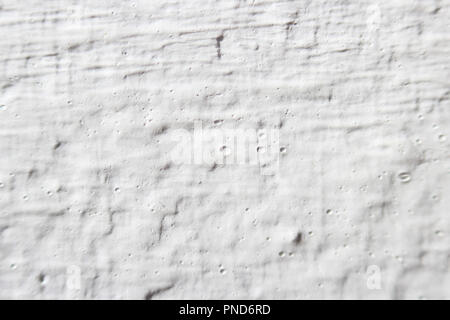 Decorative plaster effect on wall. white plaster lighted by daylight Stock Photo