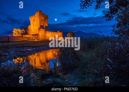 A dusk-time view of the magnificent Ross Castle, located on the edge of Lough Leane in Killarney National Park, Republic of Ireland. Stock Photo