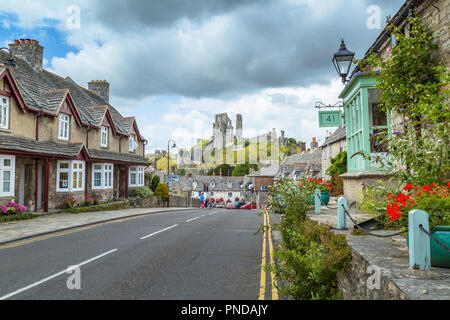 The village of Corfe Castle with the castle itself on the hill beyond. Stock Photo