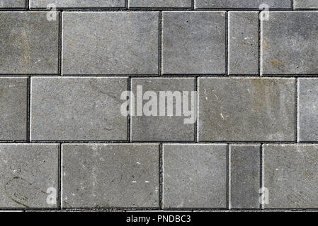 Concrete or cobble gray pavement slabs or stones  for floor, wall or path. Traditional fence, court, backyard or road paving. Stock Photo