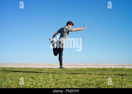 man stretches the body before running space for text Stock Photo