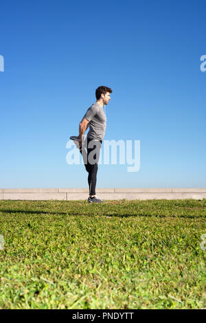 man stretches the leg before running space for text down Stock Photo