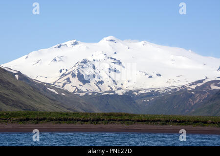 Makushin volcano, an ice covered and active stratovolcano on the island of Unalaska in the Aleutian Islands chain, southwest Alaska. Stock Photo