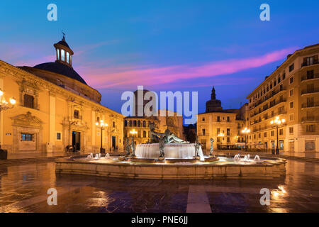 Fountain Rio Turia on Square of the Virgin Saint Mary, Valencia Cathedral, Basilica of Virgen the Helpless at night in Valencia, Spain. Stock Photo