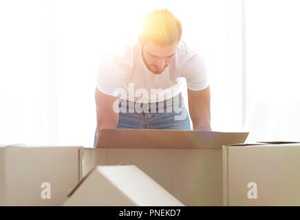 male sorting things in the new apartment. Stock Photo