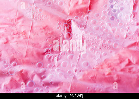 Abstract texture of a fresh juicy pink watermelon under plastic cover with condensation bubbles Stock Photo