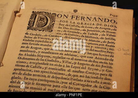 A close up view of an ancient book written in Spanish language with a big miniature at the beginning of the paragraph, on a thick yellowed paper Stock Photo