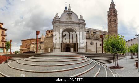 The Nuestra Señora de la Huerta gothic mudejar cathedral facade and bell tower, shot from entrance staircase, in a cloudy, autumn day, Tarazona, Spain Stock Photo