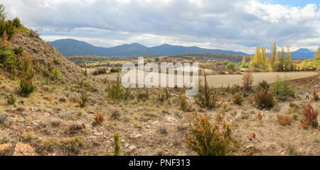 Blue cloudy sky and typical mountains and hills covered with forest met in autumn while hiking from Yebra de Basa town to Santa Orosia church, Spain Stock Photo