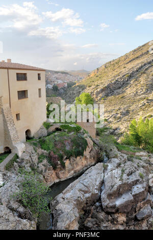 A landscape at the sunset of the rural country town of Almonacid de la Cuba, in Spain, with houses on a small rocky valley with the Rio Aguavivas Stock Photo