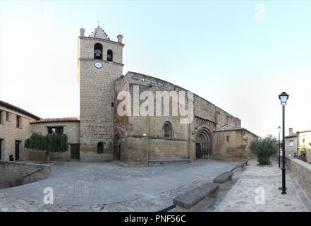 The Romanesque Nicholas of Bari Church (Iglesia de san Nicolas de Bari), with the baroque bell tower and the square in the rural El Frago, Spain Stock Photo