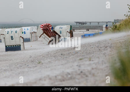 21 September 2018, Schleswig-Holstein, Heiligenhafen: A wicker beach chair blown over by a gust of the storm front 'Elena'. The first heavy gusts of wind reached the North Sea coast. On Sunday, another, much stronger storm is heading for Germany. Photo: Frank Molter/dpa Stock Photo