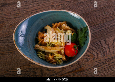 Pasta with chicken served tomato and parsley Stock Photo