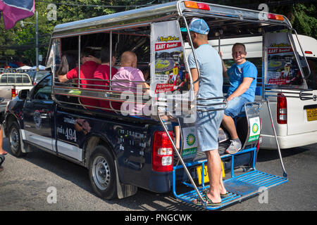 Songthaew taxi and passengers, Pattaya, Thailand Stock Photo