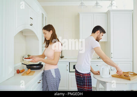 Young couple preparing food in the kitchen. Stock Photo