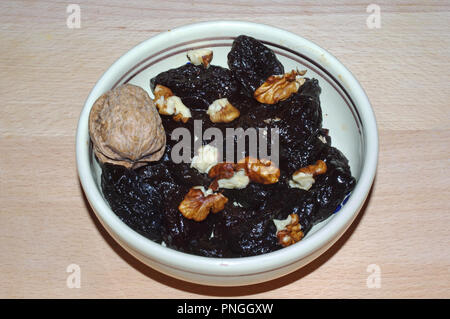 Dry plums and walnuts close-up Stock Photo
