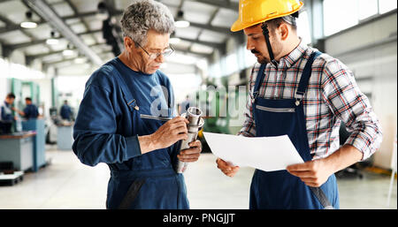 Supplier with engineer checking on production in factory Stock Photo