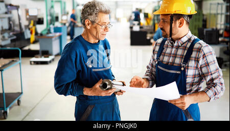 Team Of Engineers Having Discussion In Factory Stock Photo