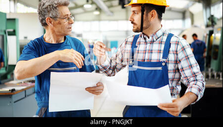 Team Of Engineers Having Discussion In Factory Stock Photo