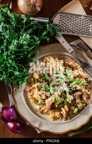 Risotto with champignon mushrooms, pork and parmesan. Italian cuisine. Top view